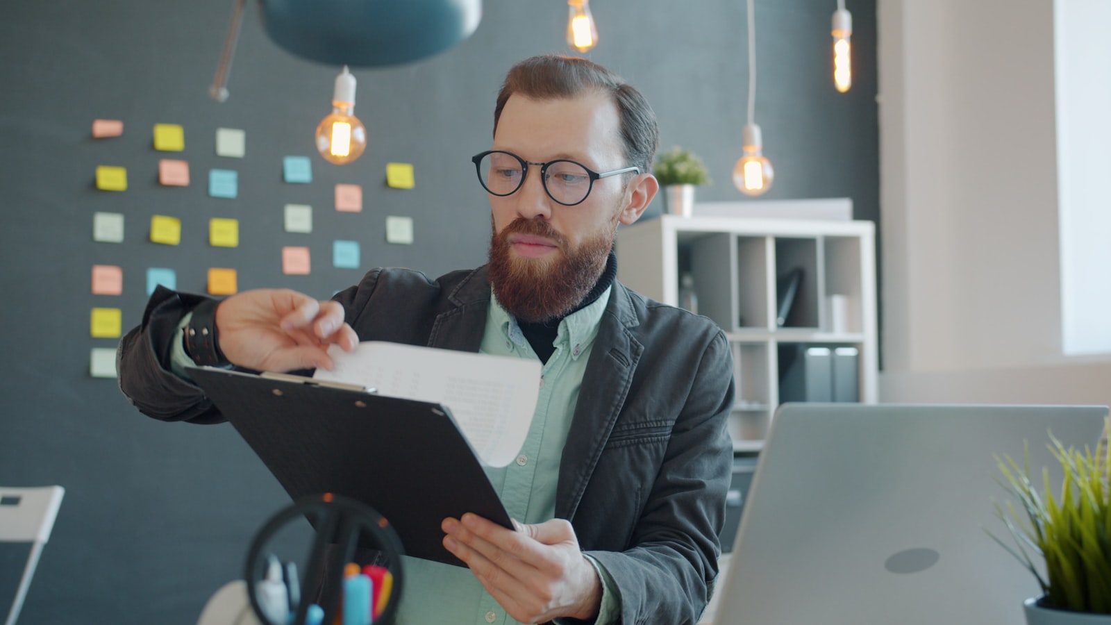 Person reviewing a clipboard at a desk
